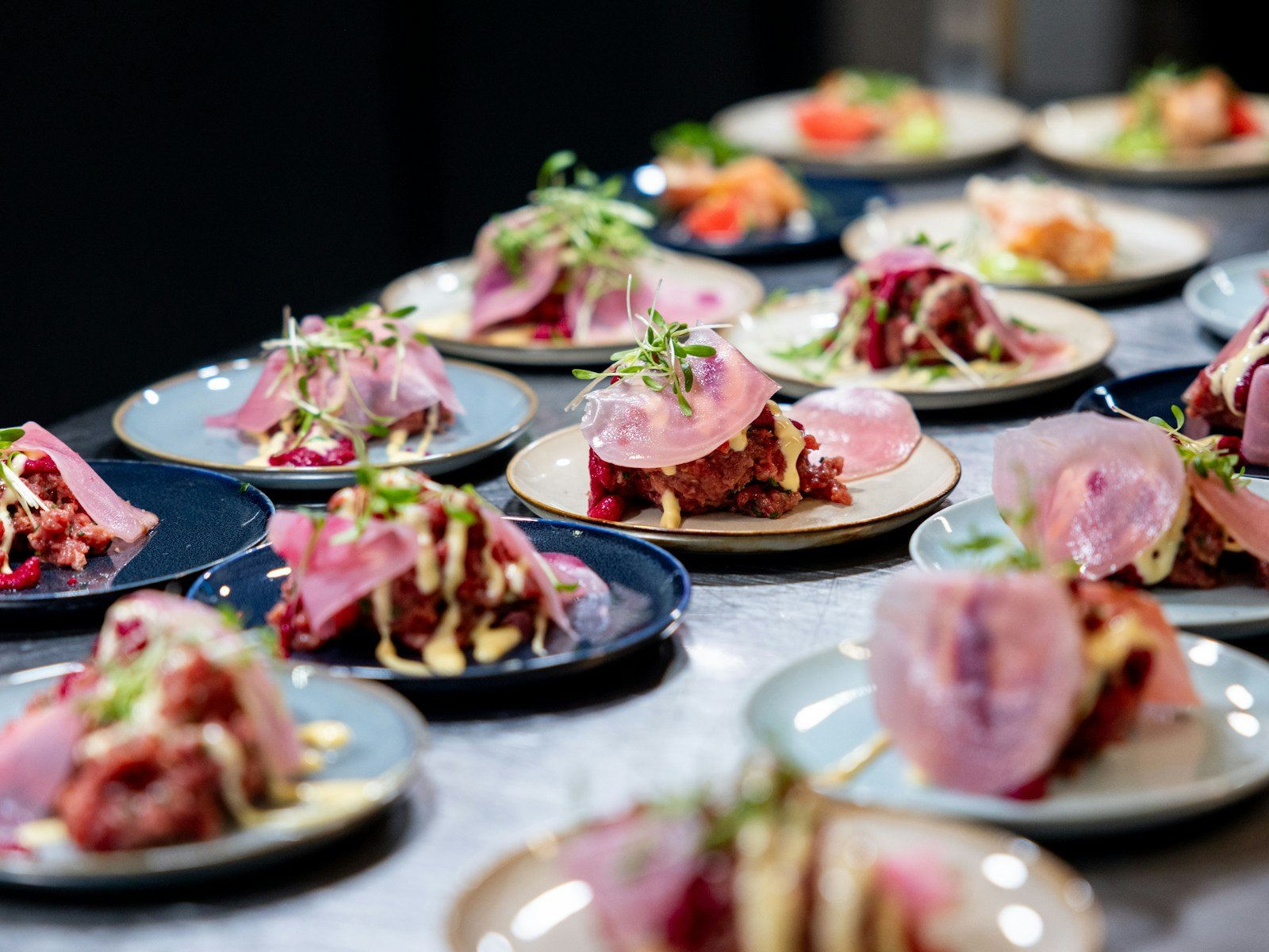 Rows of small tasting plates lined up on a table, ready to be served